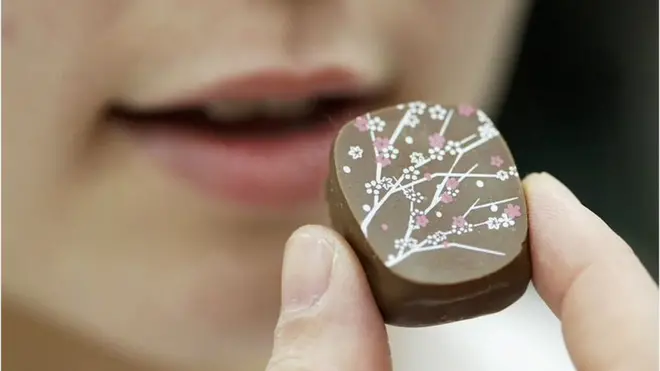 A young woman about to eat chocolate