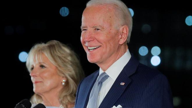 Joe Biden smiles as he speaks with his wife Jill at his side during a primary night news conference at The National Constitution Center in Philadelphia, Pennsylvania, 10 March 2020