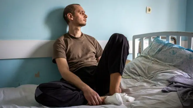 Nikita Horban sits in a medical facility in Zaporizhzhya, Ukraine. "It still hurts," he said. "The wounds are still fresh."