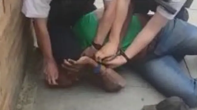 Footage on social media appears to show an officer with his knee on a man's head during an arrest