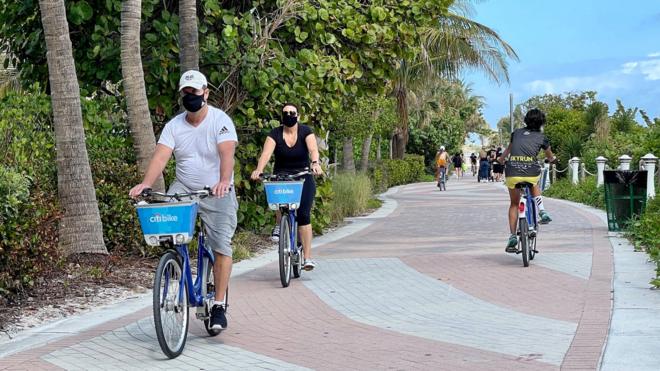 Florida tourists in masks biking