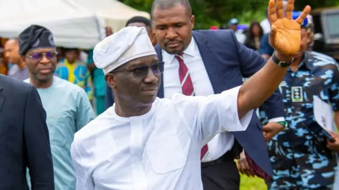 Man waving as e wear white