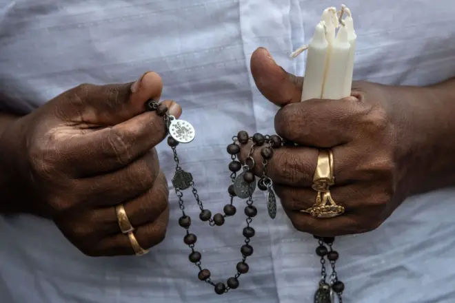A man hold a candle during the fourth annual commemoration of the victims of the Easter Sunday attacks at Saint Anthony's Shrine, Kochchikade in Colombo on April 21, 2023.
