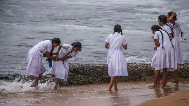School children playing at the beach