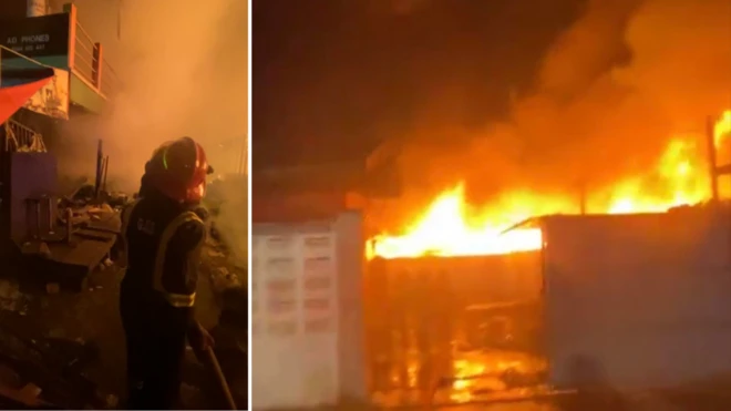 Firefighter trying to quench Katamanto market fire