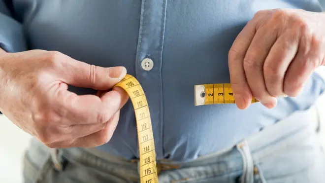 Middle-aged man with a tape measure
