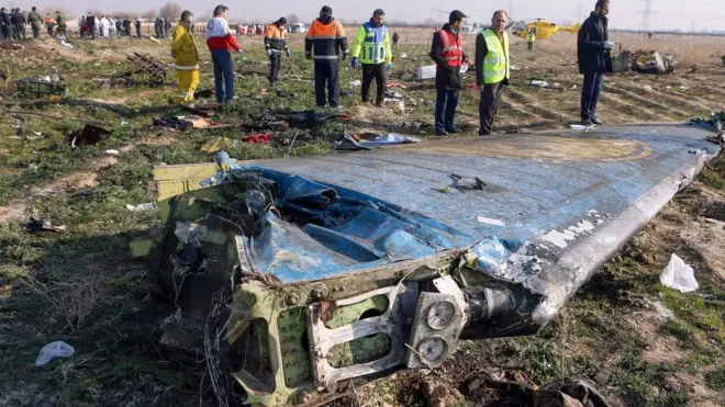 Rescue teams inspect the wreckage of Ukrainian International Airlines flight PS752