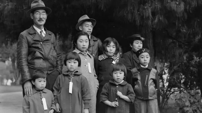 The Mochida family waits for a bus in Hayward, California that will take them to an "assembly center" in 1942