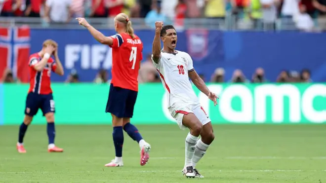 England player raise im hand in jubilation