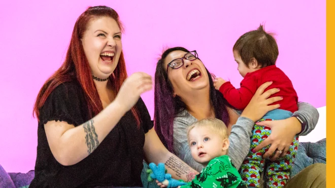 Smiling mothers and children on sofa
