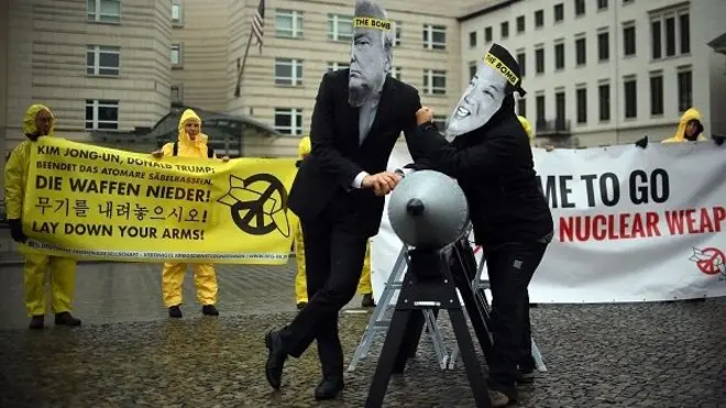 นักเคลื่อนไหวกลุ่มไอแคน สวมหน้ากากประธานาธิบดีโดนัลด์ ทรัมป์ ของสหรัฐฯ และนายคิม จอง อึน ผู้นำสูงสุดของเกาหลีเหนือ ระหว่างการทำกิจกรรมต่อต้านอาวุธนิวเคลียร์ที่หน้าสถานทูตเกาหลีเหนือในกรุงเบอร์ลินของเยอรมนีเมื่อวันที่ 13 ก.ย. ที่ผ่านมา