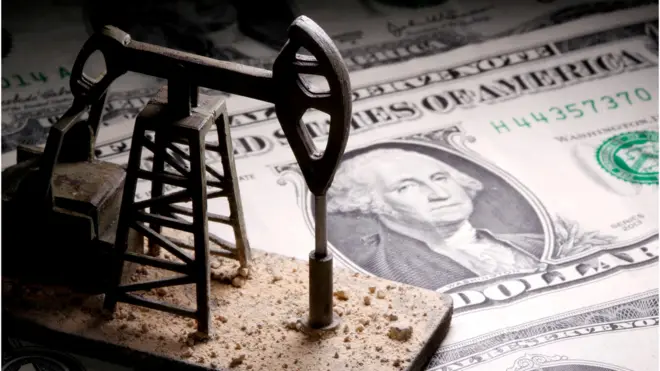 A 3D-printed oil pump jack is placed on dollar banknotes in this illustration picture, April 14, 2020.