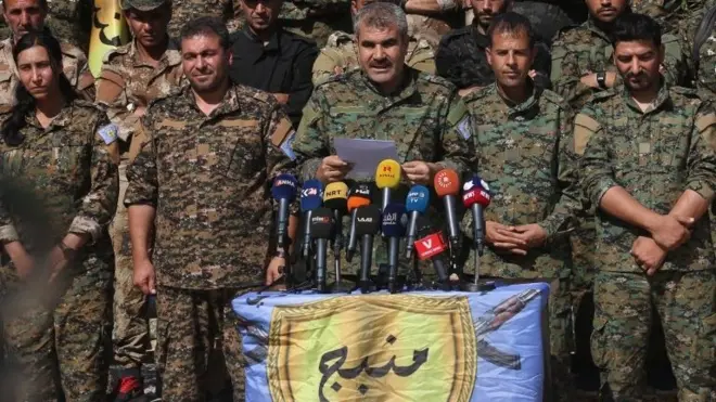 عقد الناطق باسم مجلس منبج العسكري شيرفان درويش مؤتمراً صحفياً في منبج في 6 يونيو/حزيران 2018. وقال أن وحدات حماية الشعب سحبت بعض مستشاريها العسكريين لتجنب مخاوف حدوث صدام مباشر بين حلفاء الناتو واشنطن وأنقرة.