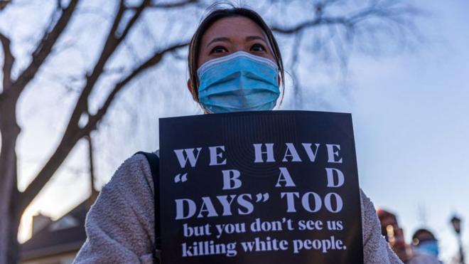 Hilary Hill Nc holds sign during the "Asian Solidarity March" rally against anti-Asian hate in response to recent anti-Asian crime on March 18, 2021 in Minneapolis, Minnesota