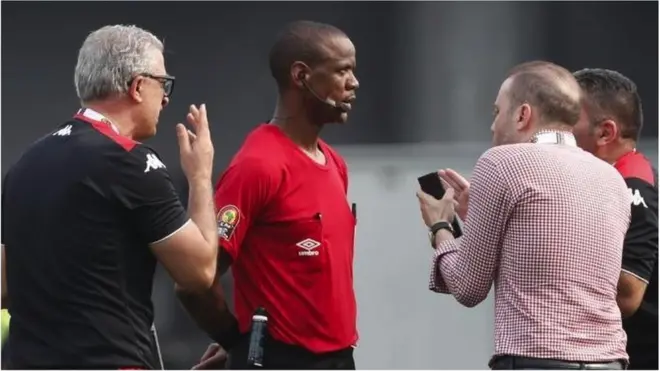 Tunisia coach Mondher Kebaier (left) and back-room staff remonstrate with referee Janny Sikazwe