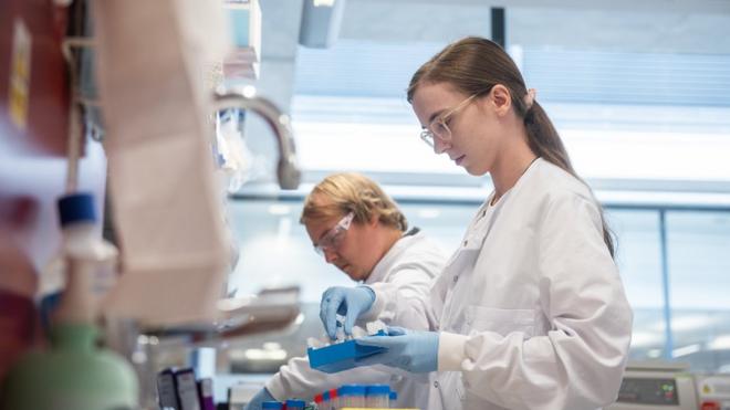 Laboratory scientist / technician handling blood samples from coronavirus vaccine trials inside Oxford University's Jenner Institute on June 25, 2020