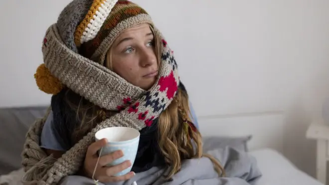 Woman wrapping up warm