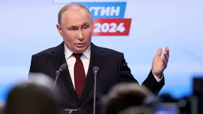 Russian presidential candidate and incumbent President Vladimir Putin visits his election campaign headquarters