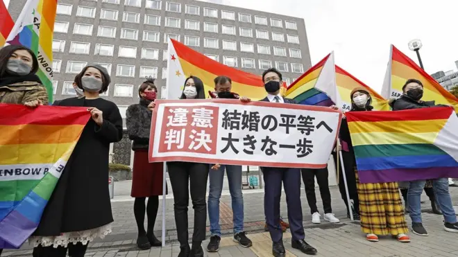 Plaintiffs" lawyers and supporters show a banner that reads "Unconstitutional decision" after a district court ruled on the legality of same-sex marriages outside Sapporo district court in Sapporo, Japan