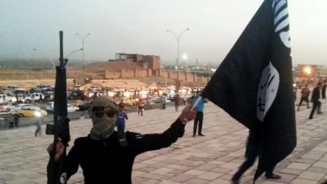 IS took control of Mosul two years ago. Pictured: An IS fighter holding a flag in the city