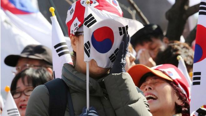 A supporter of South Korean President Park Geun-hye weeps during a rally opposing her impeachment near the Constitutional Court in Seoul, South Korea, Friday, 10 March 2017.