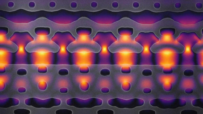 ภาพนี้ผ่านการขยายใหญ่ 25,000 เท่า เพื่อแสดงให้เห็นส่วนหนึ่งของเครื่องเร่งอนุภาคบนซิลิคอนชิป ลำแสงสีเหลืองและม่วงคือเลเซอร์อินฟราเรดที่ใช้เร่งอิเล็กตรอน