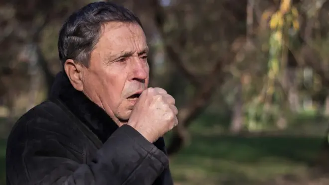 man coughing