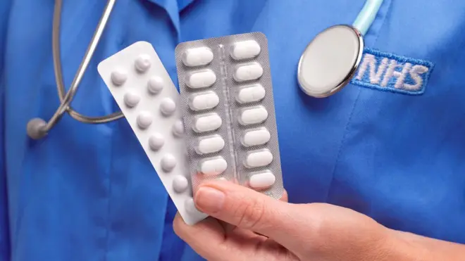 nurse holding tablets
