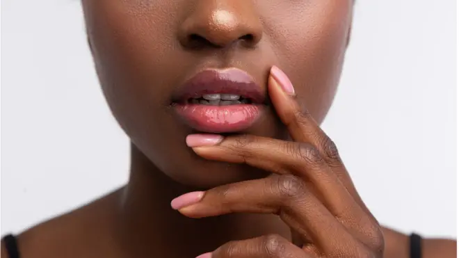 A woman holds her hand near her mouth