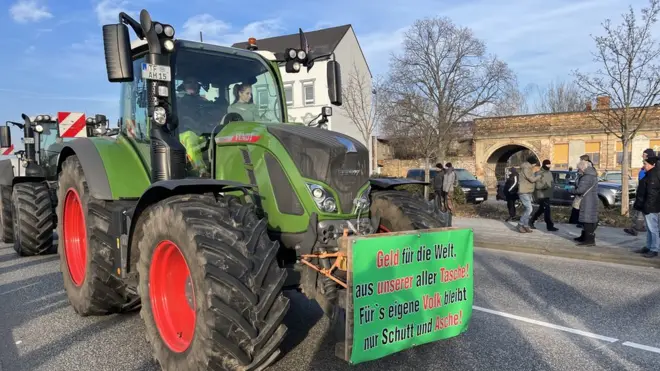 A sign at the Cottbus demo reads: “Money out of our pockets for all the world, but for our own people only rubble and ashes”