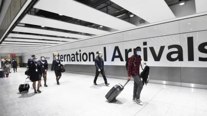 Travellers arrive at London's Heathrow Airport