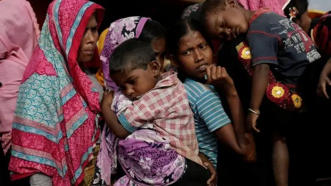 Rohingya refugees line up for a food supply distribution at the Kutupalong refugee camp near Cox's Bazar, Bangladesh 12 December 2017.