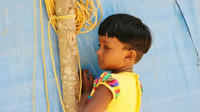 Close-Up Of Girl Crying While Standing By Tarpaulin