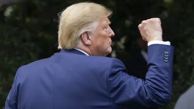 US President Donald Trump reacts after receiving a plaque from US sheriffs at the White House in Washington