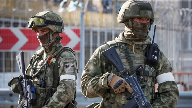 Russian servicemen stand guard near the Kakhovka Hydroelectric Power Plant near Kherson, Ukraine - 20 May 2022