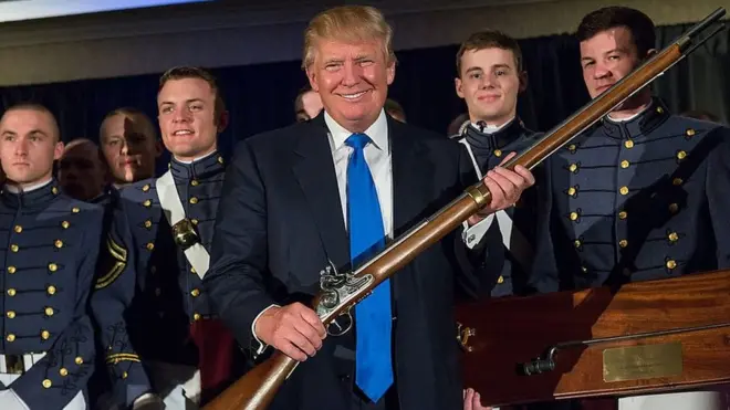 Donald Trump holding a long gun