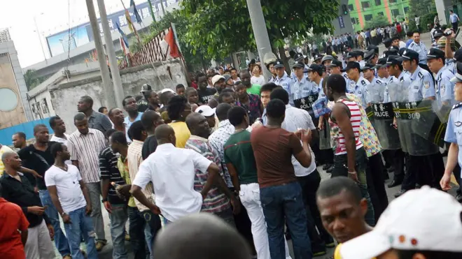 Some Policemen for Guangzhou, China dey block some Africans.