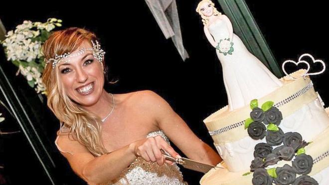 Laura Mesi, who married herself, cuts her wedding cake