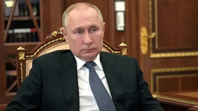 Russian President Vladimir Putin listens to Governor of the Novgorod Region Andrei Nikitin during a meeting at the Kremlin in Moscow, Russia March 22, 2022