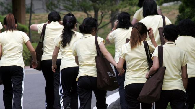 Image shows North Korean defectors walking at the South Korean Hanawon resettlement facility on July 8, 2009 in Ansung, South Korea