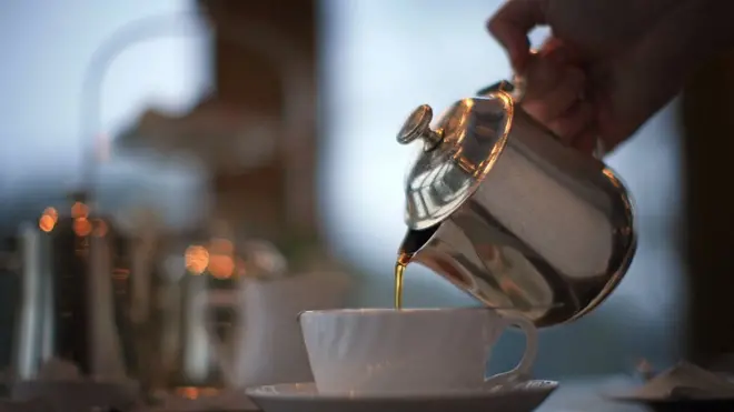 Waitress pouring tea at Bettys Tea Room, Harlow Carr in Harrogate