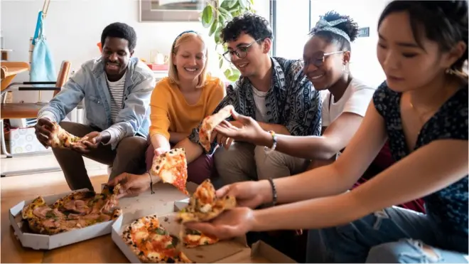 housemates sharing a pizza