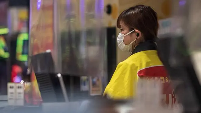 Woman working at a shop checkout