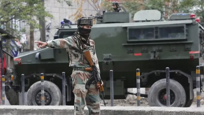 An Indian Army soldier stops vehicles (unseen) near Badam Bagh during restrictions in civil lines area of Srinagar, the summer capital of Indian Kashmir, 27 August 2016.