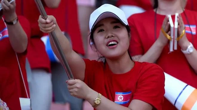 A North Korean football fan watches North Korea play South Korea at the East Asian Cup in 2015.