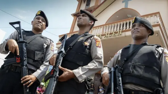Police stand guard outside a church in Banda Aceh on May 13, 2018 following attacks on churches in Surabaya, East Java.
