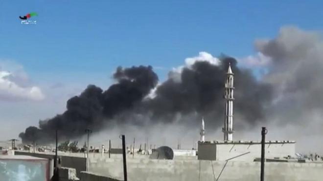 In this image made from video provided by Homs Media Centre, smoke rises after airstrikes by military jets in Talbiseh, Homs province, 3- Sept