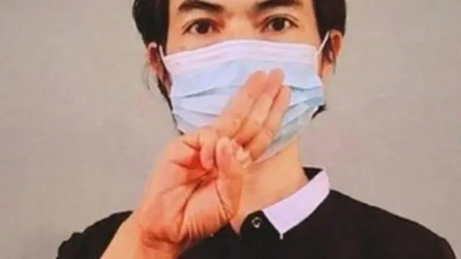 Agne Lay flashes a gesture in support for Burma's civilian opposition