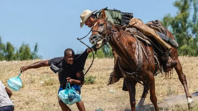 A United States Border Patrol agent on horseback tries to stop a Haitian migrant from entering an encampment on the banks of the Rio Grande near the Acuna Del Rio International Bridge in Del Rio, Texas, on 19 September 2021