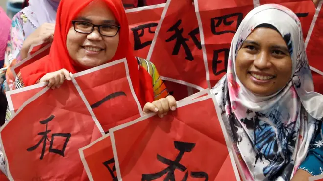 Malay teachers in Kuala Lumpur pose at a Chinese calligraphy event for the Year of the Pig
